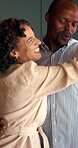 Dancing, couple and laughing in home kitchen with energy, romance and connection with love. Dance, african man and woman in healthy marriage with commitment, partner and security in house together