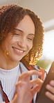Happy, woman and relax at house with phone, social media and browsing website for comedy video. Smile, African person and laugh in home with mobile, reading funny meme and streaming for weekend break