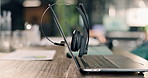Empty, office and laptop on desk in call center for financial consulting, trading advice and investment. Workplace, background and computer with headset for contact us, loan support or finance agency