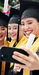 Happy, students and selfie at university with graduation, diploma achievement or education memories. Japanese people, friends and smile at college outdoor with scroll, degree success and photography.