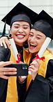 Students, graduation and selfie at university with hug, smile and excited for education certificate. Happy, Japanese women and friends at college outdoor with scroll, embrace and photo for memories.