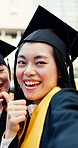 Selfie, face and women at graduation with thumbs up, success and memory at university. Portrait, graduate and happy Asian students with emoji, celebration and excited for education milestone in Japan