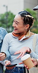 Happy, people and chatting with phone in city for social media, connection or network together. Asian woman, friends or discussion with smile on smartphone for internet, app or post in an urban town