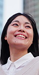 Woman, happy and travel in city with thinking, wonder and awe of urban location with perspective. Asian person, outdoor and trip downtown with smile, sightseeing and vacation mindset in Japan