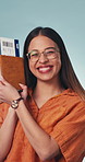 Face, woman and excited in studio with passport, visa approval and flight ticket for travel. Portrait, female person or dance with boarding pass, confirm booking and holiday abroad on blue background