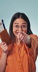Face, woman and pointing in studio with passport, flight ticket and selection for travel. Portrait, excited or female person with come gesture, boarding pass and holiday invitation on blue background