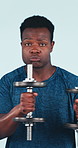 Face, black man and dance in studio with dumbbells, fitness and strength training for wellness. Portrait, male person and rhythm with equipment, energetic workout and bodybuilding on blue background