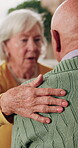 Friends, hand and elderly people with care, support and appreciation for lifelong relationship. Empathy, senior woman and man in retirement home for visit, compassion or talking with connection