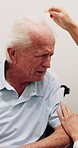 Wheelchair, old man and comb hair with caregiver in homecare for grooming, clean and hygiene. Nurse, elderly person with disability and help for self care, serious or talking in assisted living home