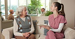 Question, caregiver and senior woman in nursing home for wellness report, feedback and check up. Retirement, clipboard and nurse with elderly person for assisted living, help and talking for support