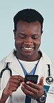 Doctor, scroll and black man in studio with phone, telehealth website or internet for medical research. Happy, healthcare worker or person with tech, text message and social media on blue background.