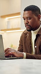 Laptop, typing and black man in home for remote work, timesheet or report for HR administration. Human resources, African person and review with employee hours, payroll and planning project with tech