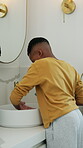 Boy, brushing teeth and dental care in home with cleaning, personal hygiene and health with rinse. Water, faucet and African child in bathroom for oral wellness, toothbrush and fresh breath by basin