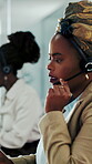 Agent, woman and consulting on headset in callcenter for cold calling, explain offer and serious. Sales, black person and mic in telemarketing for product knowledge, lead generation and coworking