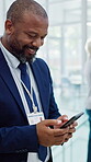 Healthcare, doctor and man with phone in hospital, networking and communication with contact on web. Clinic, mature medical professional and black person with mobile for chat, happy and health update