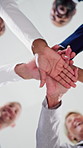 People, doctor or unity with hands together in hospital for collaboration, solidarity or teamwork below. Low angle, group or healthcare workers piling with smile or stack for support in clinic
