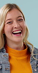 Face, woman and laugh in studio with funny thought, positive attitude and optimistic for wellness. Happy, person and good mood with satisfaction, humor and joke for stress relief on blue background.