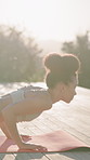 Woman, plank and fitness on patio for yoga, mobility and holistic balance for wellness. Space, female person and yogi in nature with cobra position, flexibility and practice pilates for self care