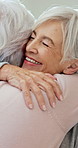 Care, friends and senior women with hug, smile and welcome for bonding together at home. Retirement, happy people and embrace with love, reunion and visit with support for connection in apartment