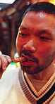Eating, thinking and asian man with skewer in Japan for meal, sightseeing or taste in market. Thoughtful, male person or travel with street food for outdoor dinner, snack or wonder in city or town