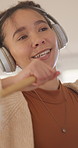 Headphones, singing and woman in home for spring cleaning, chores or dusting on weekend. Dance, karaoke and person with audio tech for listening to music, playlist or album online for housekeeping.