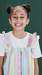 Wellness, face and child in studio with laugh, positive attitude or happy moment on weekend break. Smile, portrait or girl on green background with humor, good mood and confidence in youth wellbeing.
