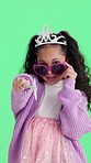 Sunglasses, princess and girl in studio with green screen for attitude, pretend and imagination. Fashion, portrait and child with wand, crown and toy for fun, games or fantasy on chromakey background
