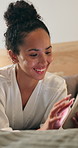 Smile, woman and relax in bedroom with phone, social media and browsing website for movies. Female person, rest and laughing at house with mobile app, comedy video and subscription for streaming film