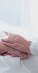 Holding hands, comfort and senior couple in hospital for empathy, care and bonding in marriage. Love, visit and elderly people with connection for trust, support or compassion at checkup in clinic.