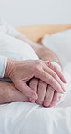 Holding hands, comfort and senior couple in clinic for empathy, care and bonding in marriage. Love, visit and elderly people with connection for trust, support or compassion at checkup in hospital.