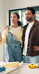 Couple, hug and talk at house for renovation, planning and interior design for makeover maintenance. People, discussion and embrace in lounge for upgrade project, diy remodeling and home improvement