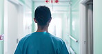 Hallway, walking and back of nurse in hospital for medical career, wellness and support for health. Professional, healthcare and woman in corridor for service, working and consulting in clinic