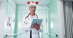 Tablet, woman and doctor in hospital with research for diagnosis information, treatment or telehealth. Digital technology, walking and mature healthcare worker with medical schedule in clinic.