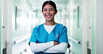 Happy, hospital and face of nurse in hallway for medical career, wellness and support for health. Crossed arms, healthcare and portrait of woman with confidence, pride and smile for friendly service