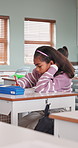 Bored, thinking and kid in classroom at school for development, growth or decision on learning. Education, serious and girl student with problem solving, fatigue or academic burnout on campus.