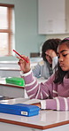 Bored, doubt and child in classroom at school for development, growth or decision on learning. Education, thinking and girl student with problem solving, fatigue or academic burnout on campus.