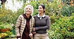 Happy, caregiver and old woman with cane at park, pointing or healthcare service for  senior patient. Outdoor, nurse and support for elderly person with disability, bonding and together in nature