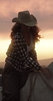 Sunset, woman and cowgirl pet horse in countryside with hat, companion and bonding together outdoor. Evening, female person and climb on stallion with affection, connection and animal care in Texas.