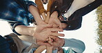 Motivation, low angle or people outdoor with handstack, victory or team support with unity. Success, solidarity or group with hands together, collaboration gesture or encouragement in milestone reach