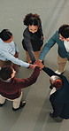 People, meeting and hands together with team applause in huddle for business mission or success. Top view, group or employees piling with stack or smile for unity, solidarity or support in workplace