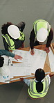 Architect, team and meeting with blueprint for building design, planning or strategy together. Top view, people or group of contractors with layout for architecture development or civil engineering