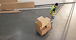 Man, boxes and trolley in warehouse for distribution, fulfillment and supply chain for stock delivery. Above person, walking or cardboard at depot with shipping, dispatch and cargo for logistics