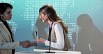 Business, podium or happy woman with handshake in award ceremony for thank you speech or achievement. Female person, presentation or shaking hands with trophy or reward for nomination or announcement