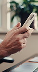 Person, hands and typing with phone in office for social media, communication or network connection. Closeup, employee or user texting with smartphone for conversation or chatting app in workplace