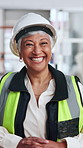 Face, woman or civil engineer at construction site, smile or helmet for safety standards in building. Mature, happy person or professional contractor with gear, development compliance or confidence
