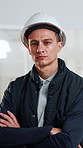 Face, man and contractor at construction site, confidence and development with safety helmet. Portrait, serious person and civil engineering professional with ppe in building, pride and arms crossed