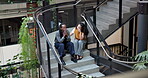 Business, comfort and stress with people on steps in office together for crisis, loss or mistake. Anxiety, conversation and fail with employee consulting colleague on stairs in workplace for support