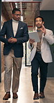 Business, tablet and talking with men in financial office for collaboration, discussion or ideas. App, finance and walking with accounting team at investment firm for planning or wealth management