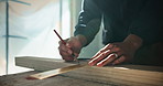 Carpenter, hands and drawing in workshop with wood beam, ruler and planning for furniture production. Man, timber and pencil mark for carpentry, DIY manufacturing or artisan with restoration project.