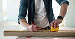Measuring, tape and hands of carpenter in workshop for furniture design or manufacturing. Man, safety gloves and woodworker with precision for timber material with industrial diy project in factory